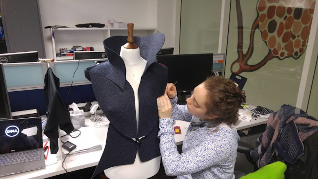 SNASI prosotype in construction. The wearable looks like a lapel with technology hidden within the collar and back piece